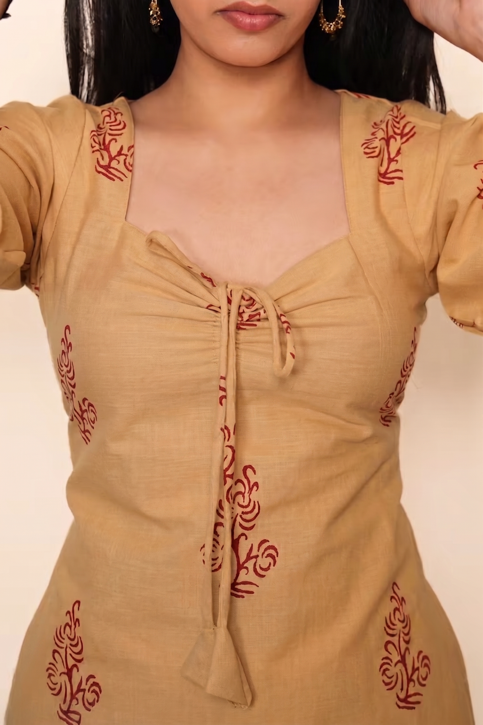square neckline, front tie-up tassels, and floral block prints.